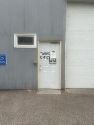 Front door with help business hours posted for summer.