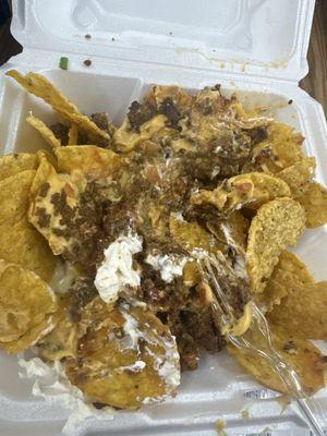 Surper nacho just meat and cheese and sour cream green onions and tomatoes where the black olives