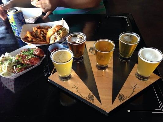 Beer sampler from the brewery and pork belly sliders with bomb dust fries, 5150 sliders, firecracker wings from belly bomz truck