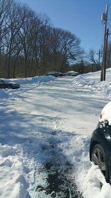 After the truck plowed and took him 3 hrs after it stopped snowing to show up. Hill too steep to drive up with the snow and ice.