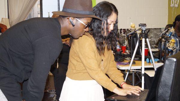 Hip hop artist Odissius and Maricela Guitierrez sign petition at 94.2 Blazin to get air conditioning installed at Los Angeles projects