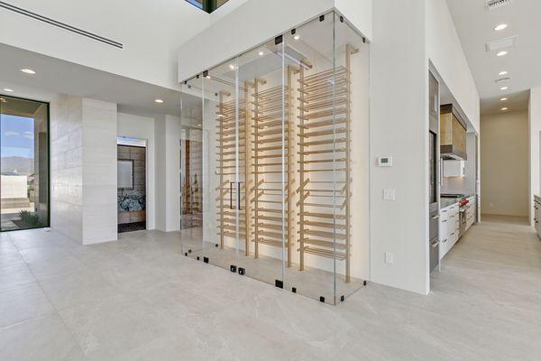 Clear Starfire glass wine cellar enclosure, tightly sealed for temperature control capabilities.