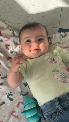 Baby on blanket with toys on quick wash floor.