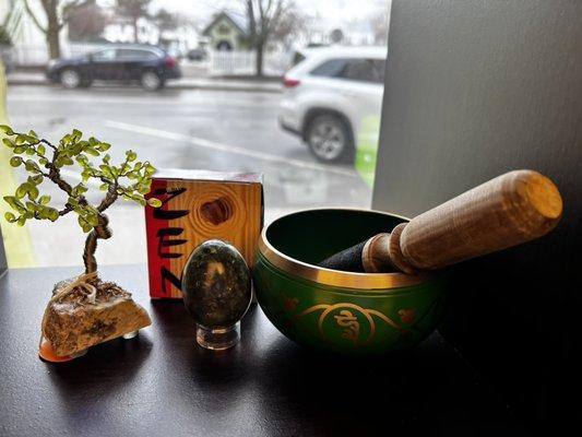 Zen sand art, jade egg and a singing bowl