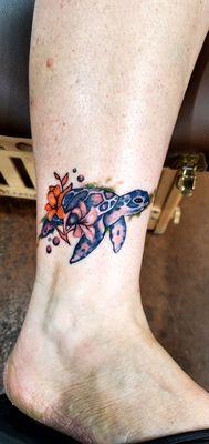 Turtle  with hibiscus flowers