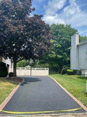 Asphalt driveway installed with 6x9 paver boarder