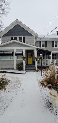 Custom Glow is located in a studio above the Shamrock Garden Florist. Use the yellow door on the left, head up the stairs and turn left.