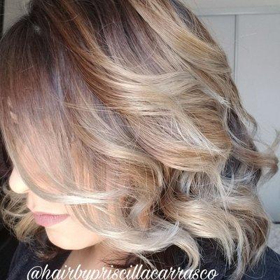 A combination of balayage & highlights with a rooty look.