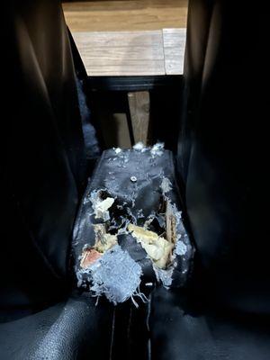 Broken arm chair between seats. They blamed it on customers who slam the arm rests.