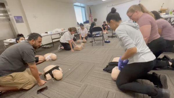 Demonstrating proper hand placement for CPR on an adult.