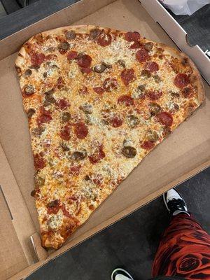 Giant slice of pepperoni and Italian sausage with extra cheese! OMG real NY pizza heaven on a slice. HUGE!
