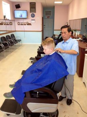 Barber "Lee" giving a personalized haircut.