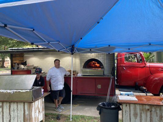 Pizza truck and prep tables.