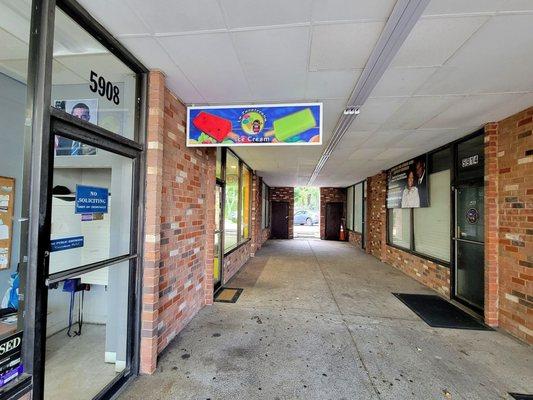 The corridor doesn't look dark when you enter it. The store is on the left.