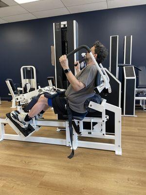 Focused lower back training on a MedX machine designed to build spinal strength and improve posture through controlled resistance.