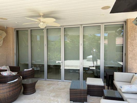 Outdoor patio update - Sleek glass doors and new finishes for an elevated outdoor living space.