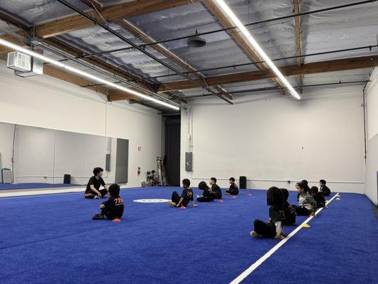 Coach Nick teaching our 4- to 6-year-old students the importance of showing respect through listening and trying their best in class
