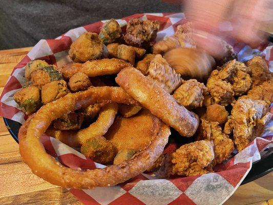 Alligator bites with fried okra and onion rings. Also served with two hush puppies.
