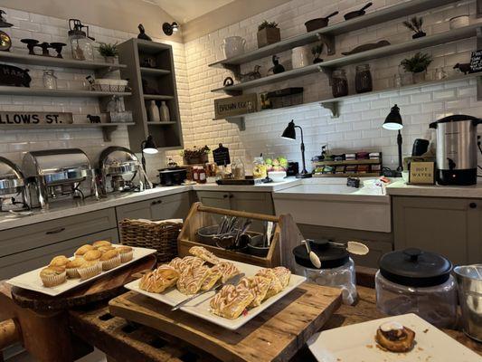 Breakfast buffet in the morning features scrambled eggs, bacon, sausage, toast, fruit and pastries.