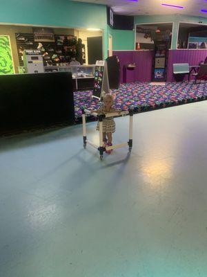 My littlest skating with a rented "skate mate"