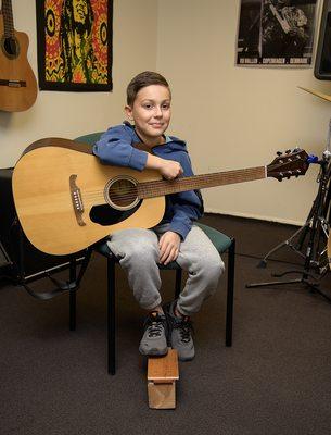 Lucas enjoying his guitar lesson