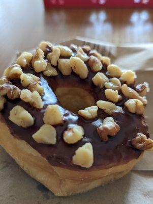 Chocolate glazed donut with nuts