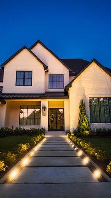 Outdoor walkway and tree lighting installed to beautifully illuminate the front of this home.