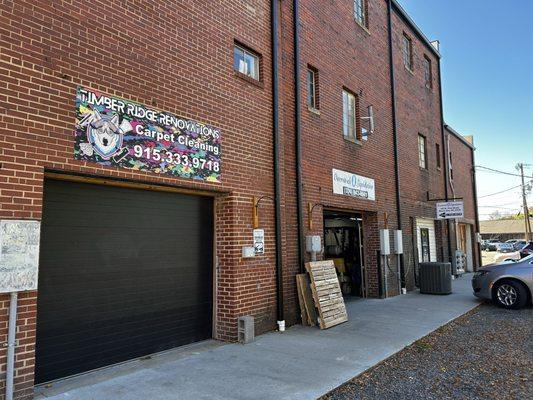 Located behind the businesses that front W Pine Street.