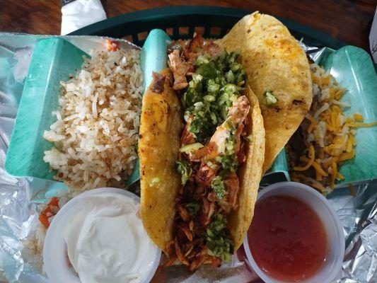 Chicken taco with a side of rice and beans
