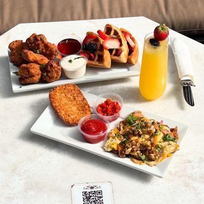 Brunch! Chicken wings with berry covered waffles, hash brown, and egg scramble with a loaded berry mimosa.