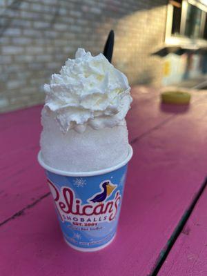 Kid size snowball with whipped cream, a classic summer time treat