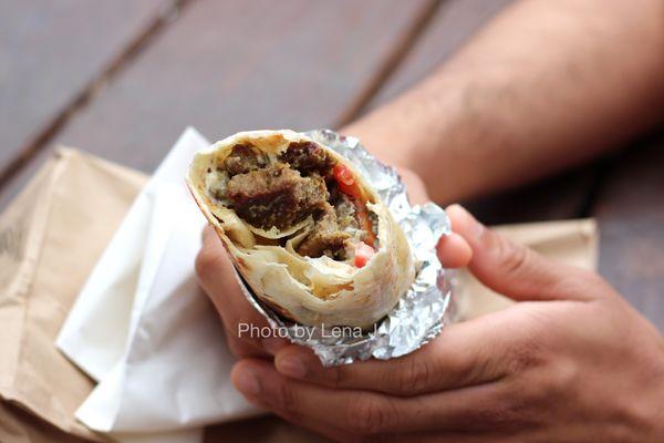 11 A. Lamb and beef shawarma sandwich ($9.55) - Grilled lamb and beef in a 12" crispy rolled pita with grilled onions and tomato