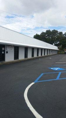 Front, entrance to retail spaces, Leasing office in unit 10, customer parking