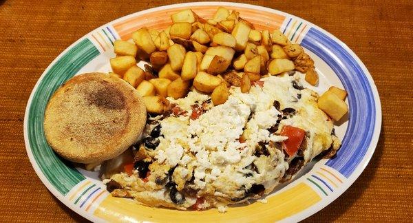 Greek omelette with fresh and crispy home fries and an English Muffin.