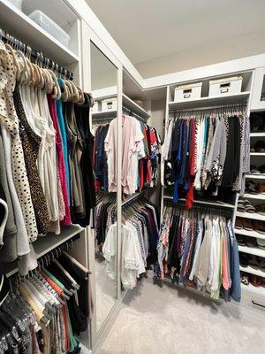 Custom walk-in closet with lots of hanging space and shelving for shoes or accessories.
