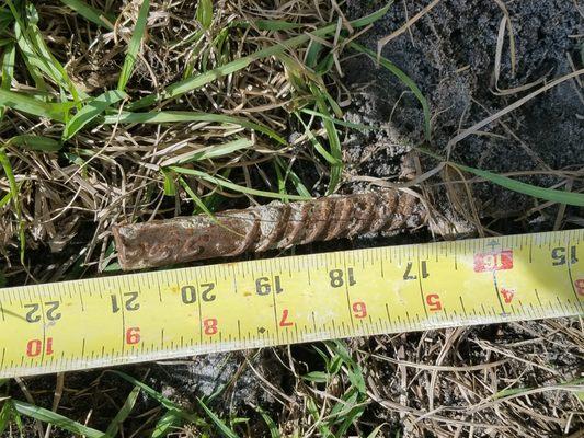 A ground rod stickinking out of the ground 21 inches. Unsafe and yet to be fixes