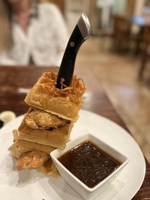 Chicken and waffles with syrup on the side