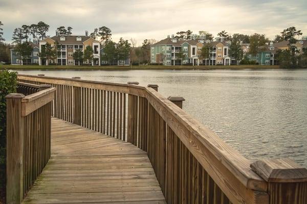 view from boardwalk across the lake and two buildings