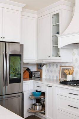 Classic white kitchen with custom cabinets, pull-out storage, and a layout built for efficiency and daily comfort.
