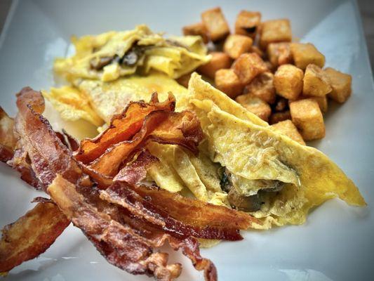 Crispy bacon, mushroom and egg omelette with crispy potatoes.