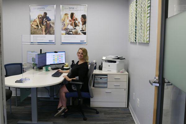 Employee working in office at Credit Union West branch in Prescott.