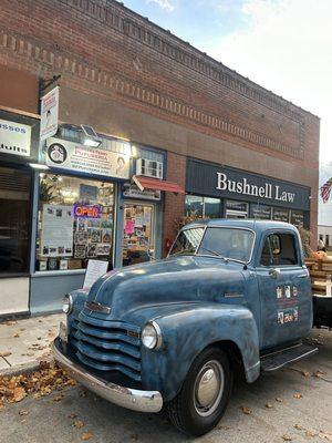 Store front and company truck that you're welcome to smoke a cigar in.