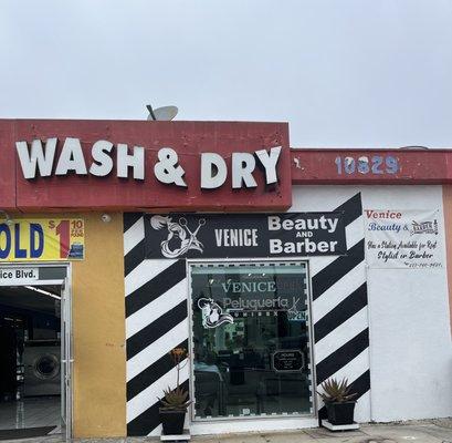 Outside of the beauty/barber shop. Entrance is via the laundromat