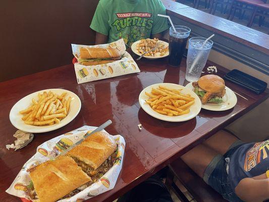 Philly poboy, hot sausage poboy, fried chicken sandwich, 1 order of cajun ranch fries, 2 orders of fries and 3 fountain drinks