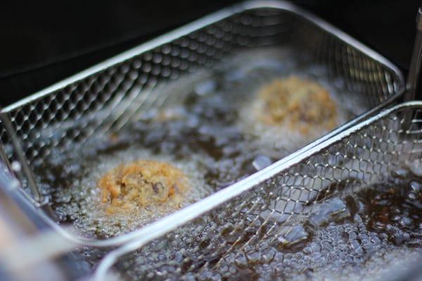 Frying up some rice balls!