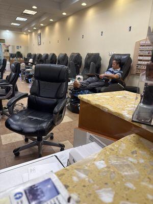 Owner with his shoes and socks off sitting directly behind me