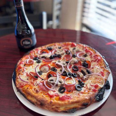 The OG - Features our house-made red sauce, layers of melted shredded mozzarella, pepperoni, onions, olives, and mushrooms.