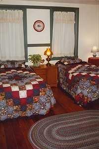 The first-floor room has three windows, an air conditioner, a private bathroom. Two twin beds can be combined into one king.