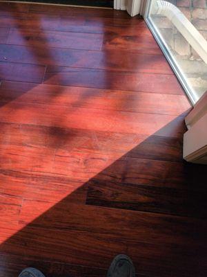 The area behind the post was sunk 3/4 of an inch. They filled it in with concrete so that it is level and cut the boards with precision