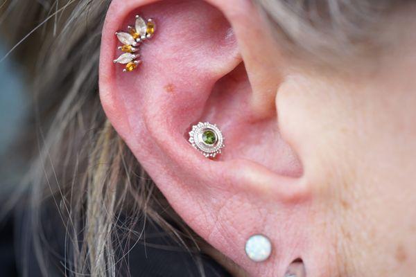 Fresh helix and conch piercing by Jessica, featuring jewelry from BVLA.